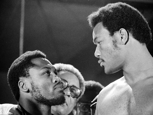 Joe Frazier and George Foreman have a close look at each other  