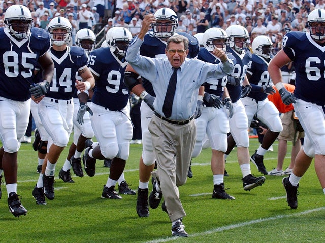 Joe Paterno leads his team onto the field 