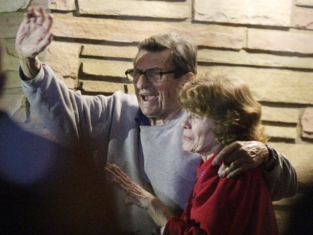 Joe Paterno and his, wife, Susan, stand on their porch to thank supporters 