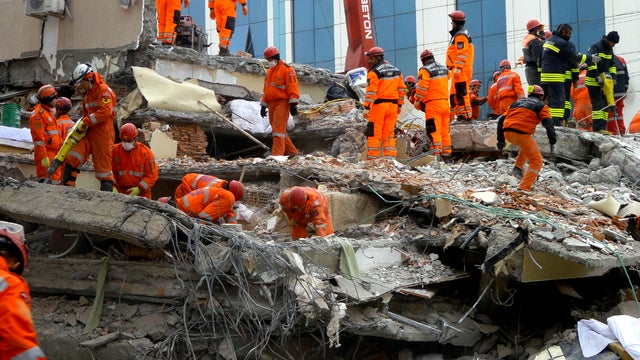 Turkish rescue workers search for survivors in the rubble of a collapsed hotel in Van, Turkey, Nov. 11, 2011. 