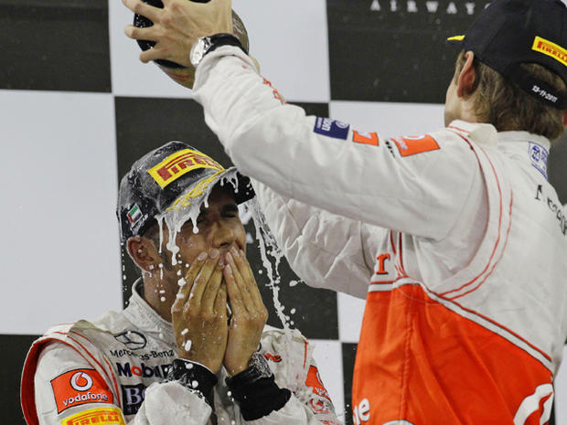 Jenson Button sprays rose champagne over winner McLaren Mercedes driver Lewis Hamilton 