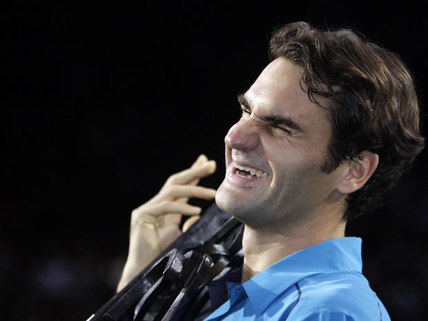 Roger Federer holds his trophy  