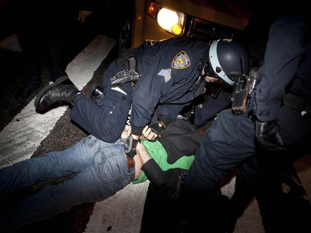 Occupy Wall Street protester is detained by police officers 