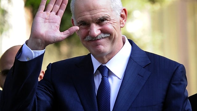 Then-Greek Prime Minister George Papandreou waves while leaving the Greek presidential palace in Athens Nov. 10, 2011. 