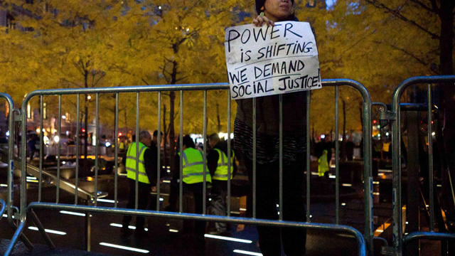 Occupy Wall Street protestor holds a sign 