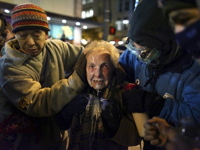 Dorli Rainey  reacts after being hit with pepper spray 