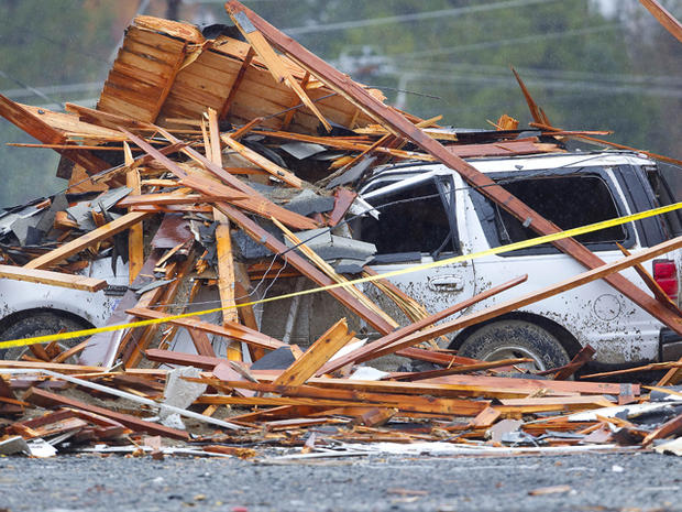 Debris covers a vehicle parked outside a business  