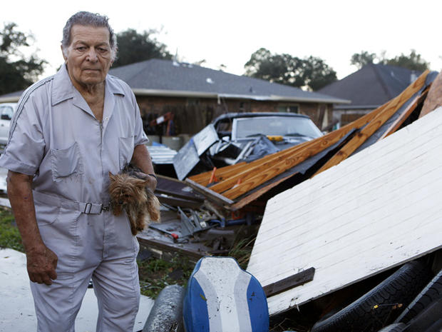 Raymond Pierce surveys damage to his property 