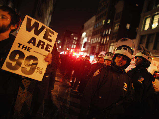 Police keep watch as protesters affiliated with the Occupy Wall Street movement march down Broadway to Foley Square Nov. 17, 2011, in New York City. Protesters attempted to shut down the New York Stock Exchange, blocking roads and tying up traffic in lowe 