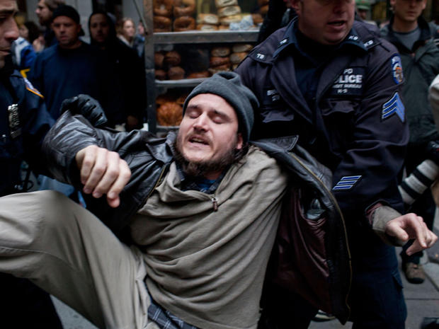 A protester affiliated with the Occupy Wall Street movement is arrested by police officers on Exchange Place in New York's financial district Nov. 17, 2011. Protesters attempted to shut down the New York Stock Exchange, blocking roads and tying up traffic 