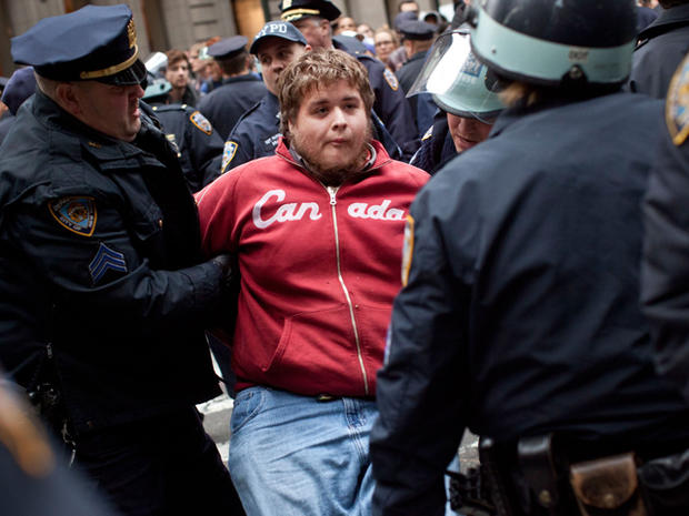 A protester affiliated with the Occupy Wall Street movement is arrested by police officers on Beaver Street in New York's financial district Nov. 17, 2011. 