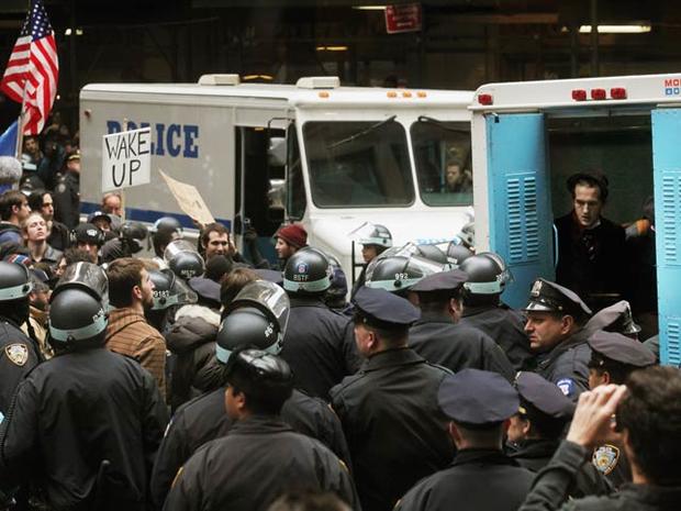A protester affiliated with Occupy Wall Street sits in a police vehicle after being arrested a few blocks from the New York Stock Exchange Nov. 17, 2011, in New York City. 