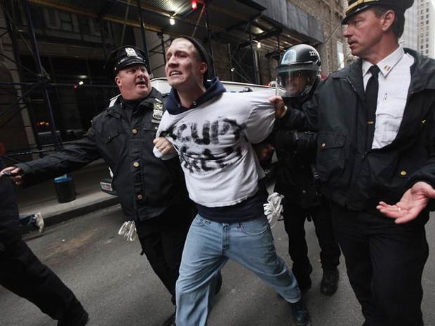 Occupy Wall Street protester Henry Cames is arrested by police a few blocks from the New York Stock Exchange Nov. 17, 2011, in New York City. Hundreds of protesters attempted to shut down the New York Stock Exchange, blocking roads and tying up traffic in 
