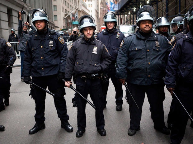Police officers stand with their batons at the ready during a march of Occupy Wall Street protesters in New York's financial district Nov. 17, 2011. 