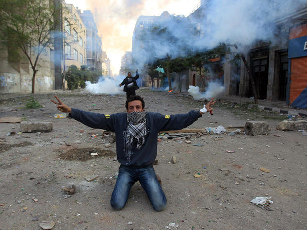 protester shows the V-sign for victory during clashes with riot police 
