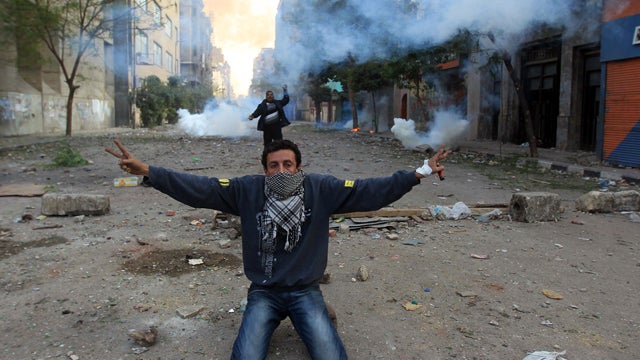 protester shows the V-sign for victory during clashes with riot police 