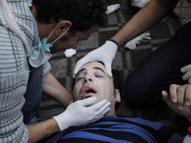 Egyptian medics help a wounded protester  