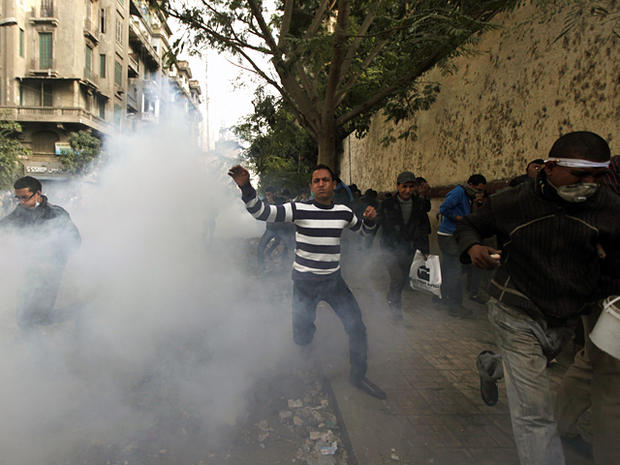 Protesters run from tear gas during clashes  