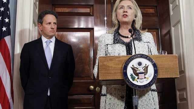 Secretary of State Hillary Rodham Clinton, speaks as Treasury Secretary Tim Geithner listens 