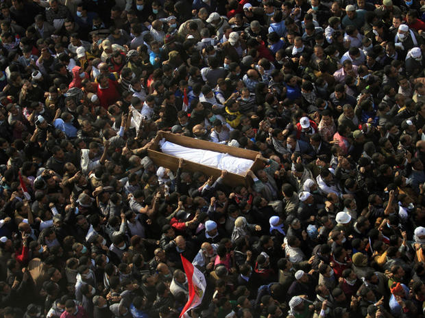 Egyptians carry a body of a protester  