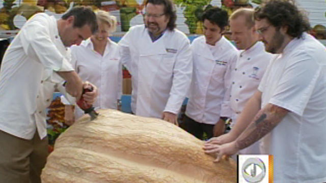 Leading NYC chef surround a 1,436-pound pumpkin donated to City Harvest. 