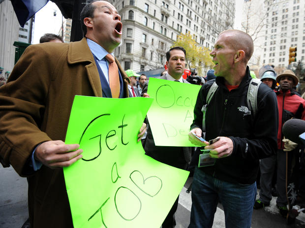 Occupy Wall Street demonstrator David Suker, right, argues with counter-demonstrator Derrick Tabacco, left, a small business owner, near the New York Stock Exchange as the Occupy movement marks two months since its birth Nov. 17, 2011, in New York. 