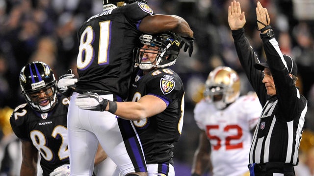 Dennis Pitta, center, celebrates his touchdown  