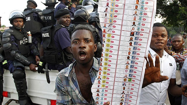 Supporters of oppositions candidate Etienne Tshisekedi parade what they claim are badly printed photocopies of election ballots they say they found in the Bandal commune in Kinshasa, Democratic Republic of Congo, Nov. 28, 2011.  