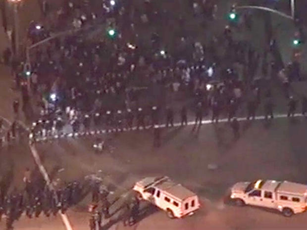 Police line up in formation to push Occupy Los Angeles protesters out of their encampment 