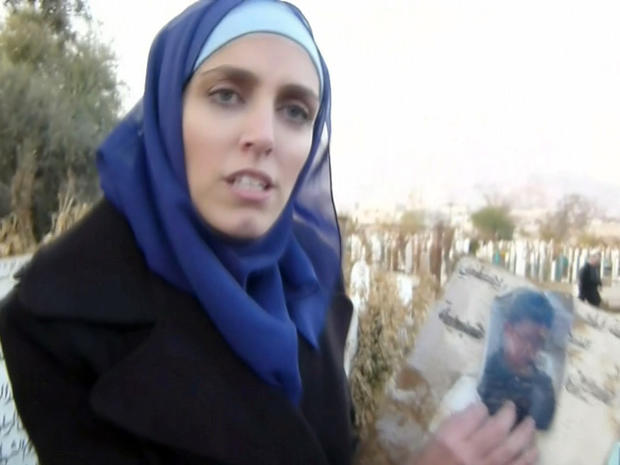 CBS News correspondent Clarissa Ward shows a photograph handed to her by a man who claimed it is of a family member who was only 13-years-old when he was killed during the protests in Syria. 