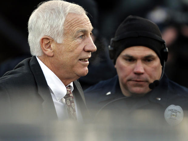 Jerry Sandusky, left, the former Penn State assistant football coach charged with sexually abusing boys, arrives for a preliminary hearing at the Centre County Courthouse in Bellefonte, Pa., where he was to face his accusers Dec. 13, 2011. 