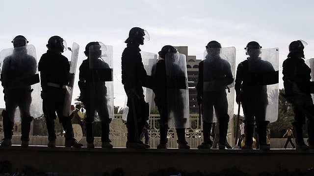 In this March 18, 2011 file photo, Riot police stand guard during a demonstration in Tahrir Square in central Baghdad, Iraq. 