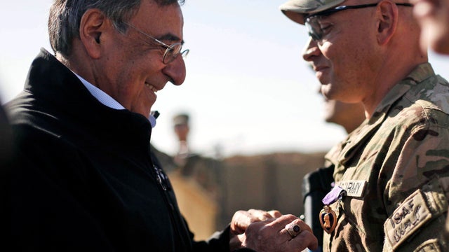 U.S. Secretary of Defense Leon Panetta presents a Purple Heart medal to Sgt. 1st Class Miguel Ortiz-Mercado during his visit to the 172nd Infantry Brigade Task Force Blackhawks at a forward operating base in Sharana, Afghanistan, Dec. 14, 2011. 