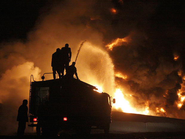 fire fighters trying to extinguish burning NATO oil tankers 