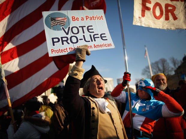 A man dressed as George Washington is saluted by Jim Griffin 