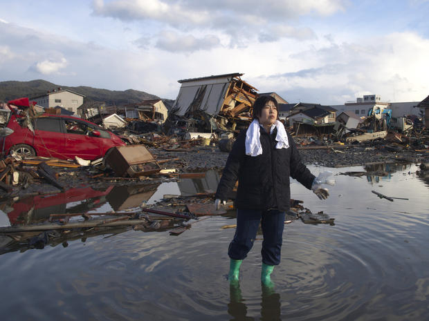 Chieko Chiba walks through the rubble  
