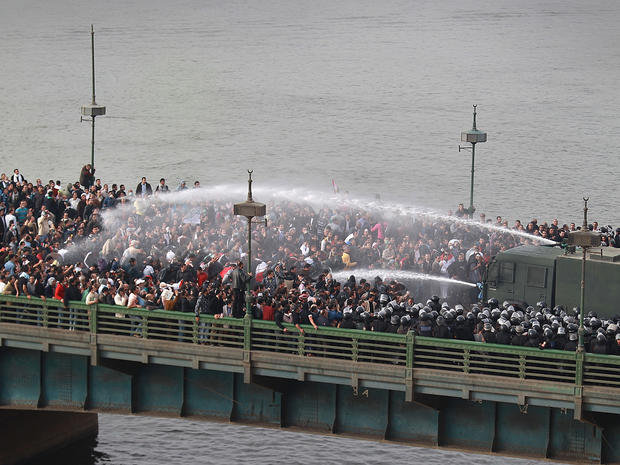 Riot police fire water cannons at protestors 