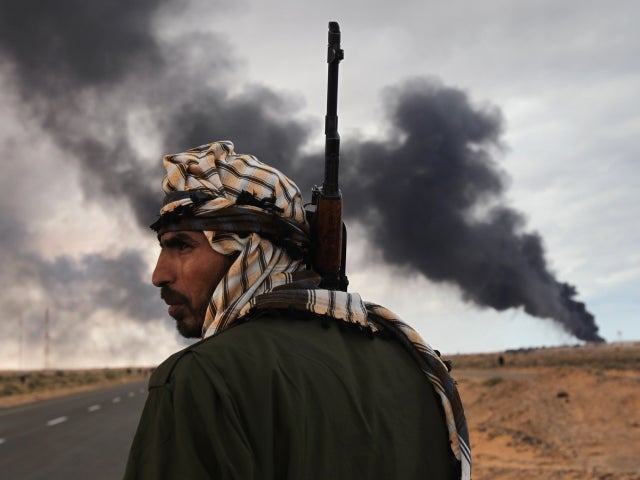 rebel scans the frontline as a facility burns 