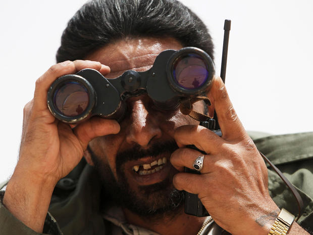 rebel commander looks through binoculars 