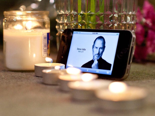 Candles, flowers, and an iPhone with Steve Jobs photo 