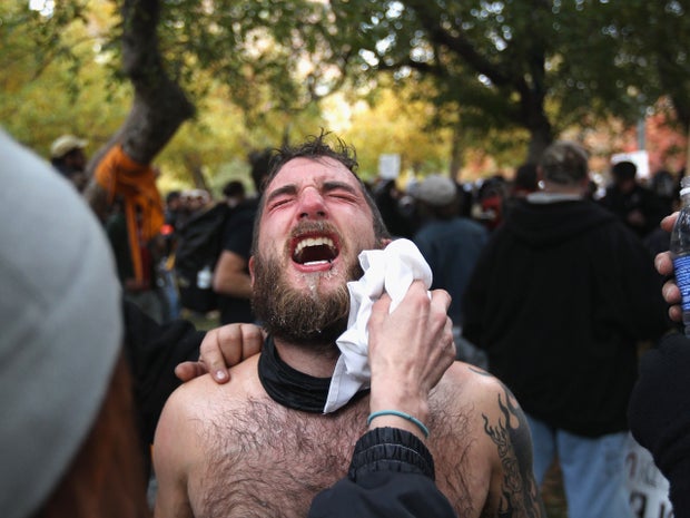 protester's face is cleaned after he was pepper-sprayed 