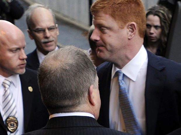 Penn State assistant football coach Mike McQueary, right, arrives at Dauphin County Court surrounded by heavy security Friday, Dec 16, 2011, in Harrisburg, Pa. 