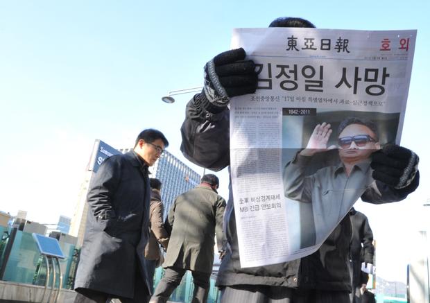 South Koreans read headlines about Kim Jong Il's passing 