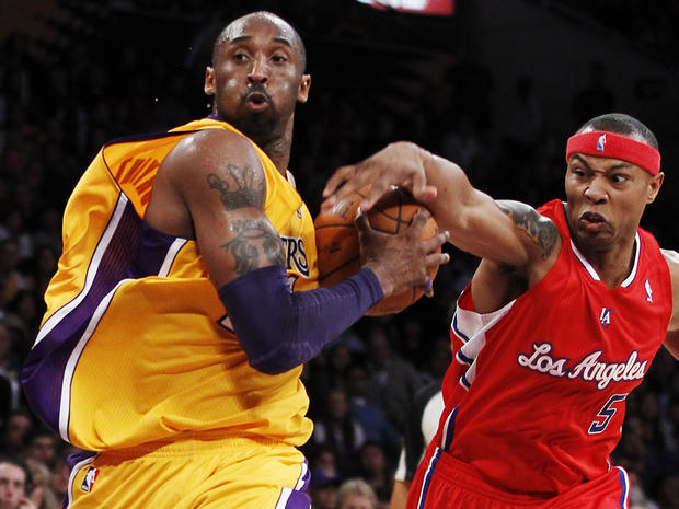 Caron Butler  attempts to knock the ball away from Kobe Bryant  