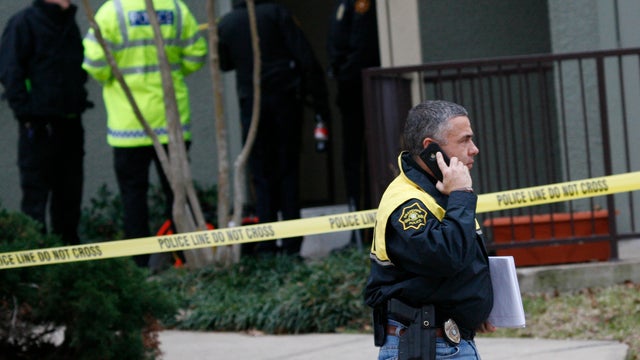 Grapevine police investigate the scene where they found seven people dead outside Dallas in Grapevine, Texas, Sunday, Dec. 25, 2011. Four women and three men who police believe to be related were found apparently shot to death, and authorities said they b 
