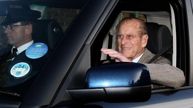 Britain's Prince Philip smiles and waves as he leaves Papworth, a specialist heart hospital, in Cambridge, England, Tuesday 