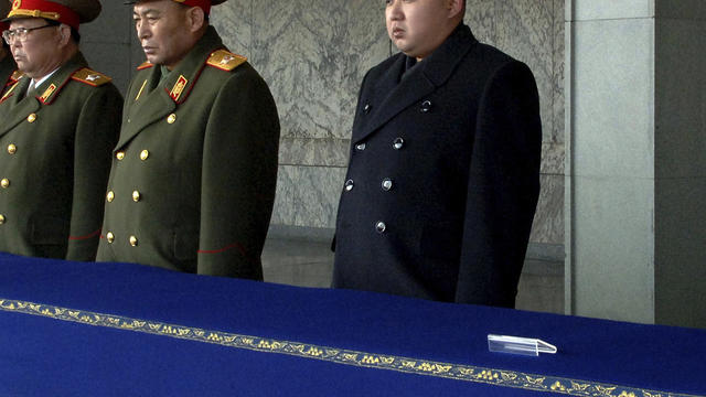 New North Korean leader Kim Jong Un, not in uniform, presides over a national memorial service for his late father, Kim Jong Il, at Kim Il Sung Square in Pyongyang, North Korea, Dec. 29, 2011. Ri Yong Ho, a vice marshal of the Korean People's Army, stands 