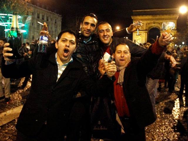 Revelers celebrate New Year's on the Champs Elysees avenue in Paris Jan. 1, 2012, in front of the Arc de Triomphe. 