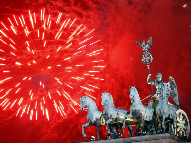 Fireworks light the sky above the Quadriga at the Brandenburg Gate in Berlin shortly after midnight, greeting the New Year Jan. 1, 2012. 