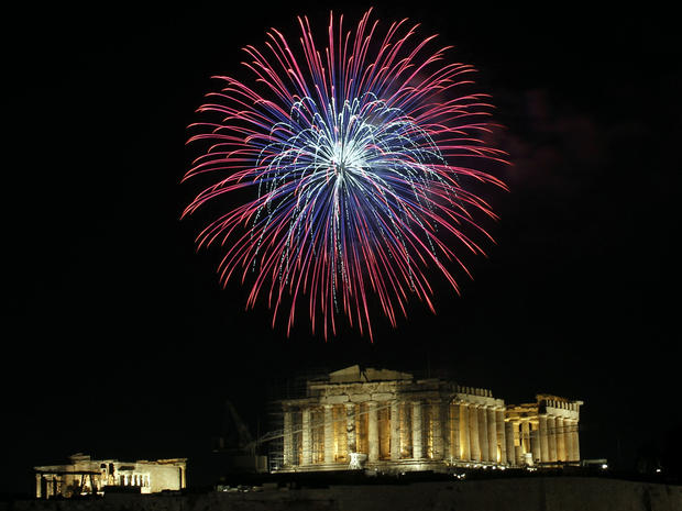 Fireworks explode over the ancient Acropolis Hill with the Parthenon temple during New Year's celebrations in Athens Jan. 1, 2012. 